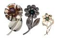 A Collection of Sterling Silver Gemstone and Glass Flower Motif Brooches