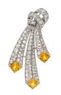 An Art Deco Platinum Yellow Sapphire and Diamond Brooch