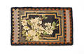 Hooked rug with floral panel and sawtooth border