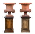 A Pair of Terra Cotta Urns on Stands