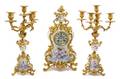 A Louis XV Style Gilt Bronze and Sevres Style Porcelain Clock Garniture