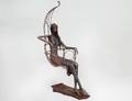 IRON FIGURE OF A WOMAN SEATED IN A CHAIR