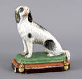 English Staffordshire pearlware figure of seated dog early 19th c