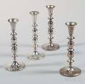 Four Cartier Sterling Silver Candlesticks