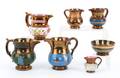 Seven copper luster pitchers