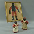 Two Polychrome Cast Iron Doorstops and a Framed Paper Puppet