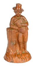 Pennsylvania or Maryland redware figure of a gentleman leaning on a stump late 19th c