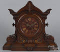 Massive carved walnut mantel clock with a marble face