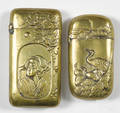 Two Japanese embossed brass match vesta safe