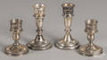Two pairs of weighted sterling silver candlesticks