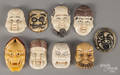 Nine Japanese carved ivory and composition mask netsukes