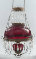 Victorian brass chandelier with a dark ruby shade and hanging prisms