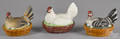 Three porcelain hen on nests
