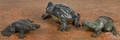 Three painted cast iron frog doorstops
