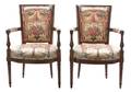 A Pair of Louis XVI Style Carved Fruitwood and Upholstered Fautueils