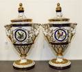 A Pair of Limoges Polychrome and Gilt Decorated Porcelain Covered Urns