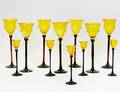 TWELVE YELLOW AND BLACK GLASS WINE GLASSES