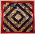Pieced log cabin quilt