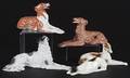 Five ceramic figures of reclining dogs