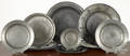 Eleven English pewter plates and shallow bowls