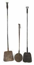 Two wrought iron peels with rams horn terminals