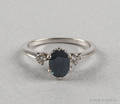 14K white gold sapphire and diamond ring with an oval blue sapphire