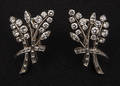 Diamond floral earrings with platinum settings containing round brilliant