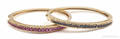 14K yellow gold matching ruby and sapphire hinged bangle bracelets