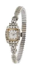 A 14 Karat White Gold and Diamond Watch Gotham