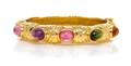 An 18 Karat Yellow Gold and Multigem Bangle Bracelet