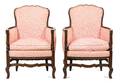 A Pair of French Provincial Louis XVI Style Walnut Bergeres