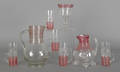Eight pieces of cranberry threaded colorless glass