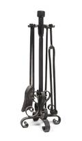A Wrought Iron Fireplace Tool Set