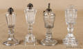Four colorless glass whale oil lamps