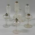 Seven Colorless Glass Oil Lamps