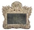 A Continental Stamped Silvered Metal Mirror