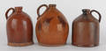 Three Pennsylvania redware jugs