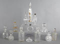 Thirteen colorless glass scent bottles