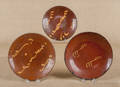 Three Pennsylvania slip decorated redware plates 19th c