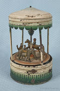 German painted tin clockwork carousel with a horse
