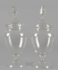 Pair of colorless glass covered urns