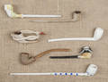 Seven clay pipes