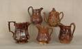 Four Rockingham glaze pitchers