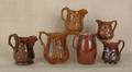 Six Rockingham glaze pitchers