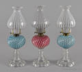 Three Victorian opalescent swirl fluid lamps