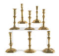 Eight English Queen Anne brass candlesticks