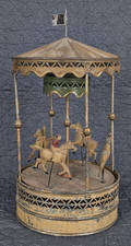 German painted tin clockwork carousel with a horse and riders