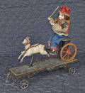 Animated bisque head doll in a goat cart pull toy