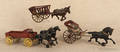 Three cast iron horse drawn toys