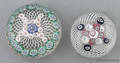 Two antique millefiori paperweights both on latticino grounds